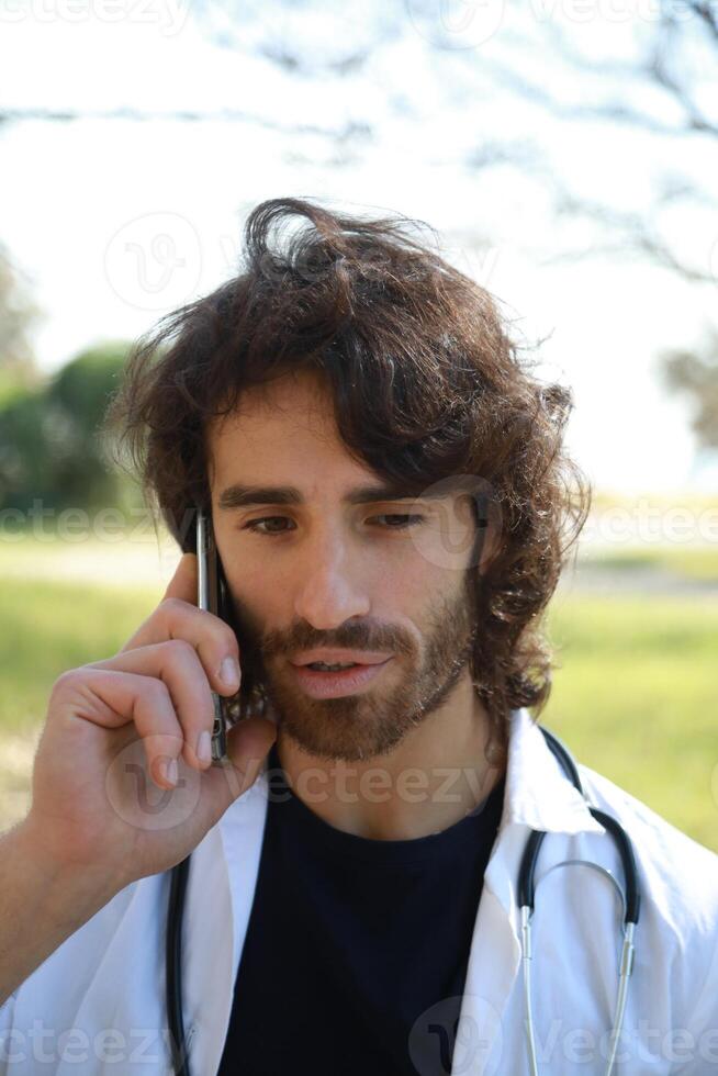 Long Hair Male Doctor Talks On The Phone Bad News The Hospital vertical photo