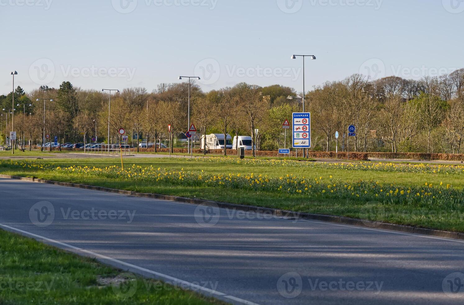Scenic Roundabout with Traffic Signs and Blooming Flowers photo
