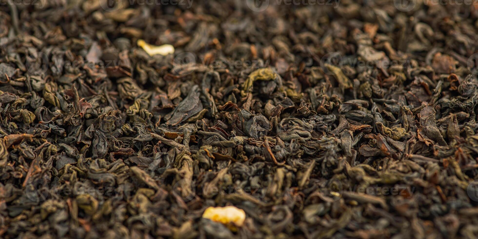 Black tea with bergamot macro photo as background. Web size photo of tea leaves.