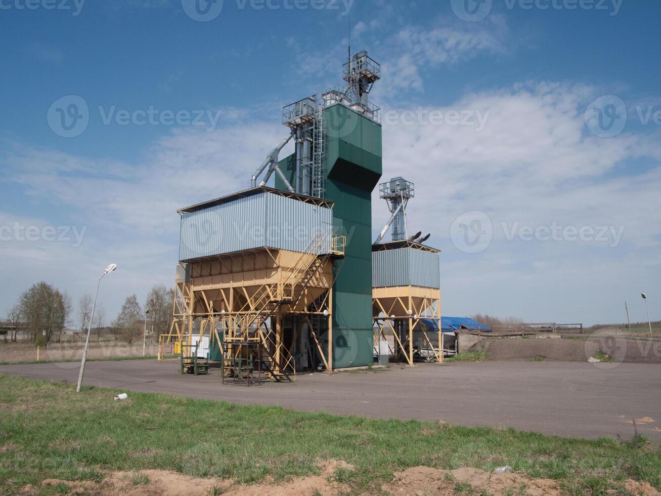 A large grain storage facility featuring tall silos and wellorganized operations set against a clear blue sky photo