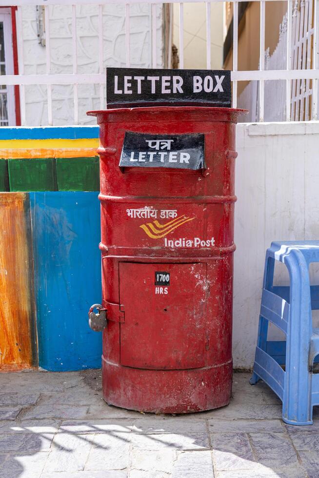 Leh, India - April 2, 2023. A red letter box from the India Post at the post office in the main market photo