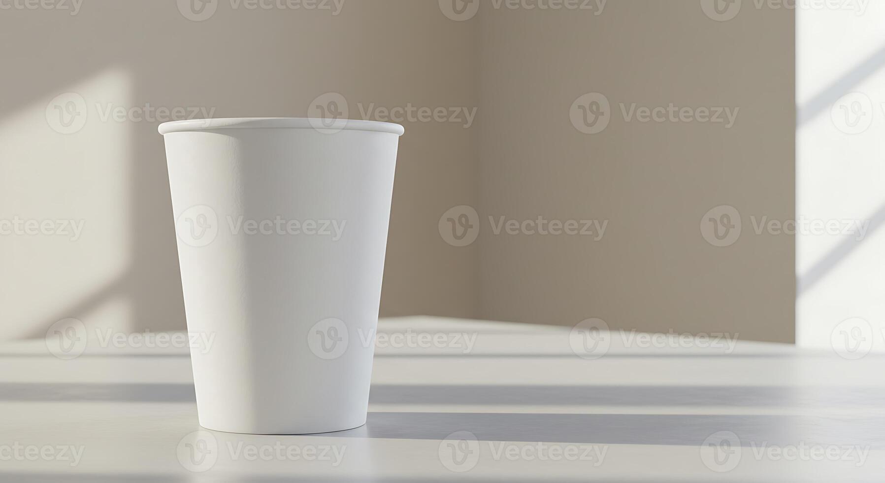 A white cup sitting on a table in front of a window photo