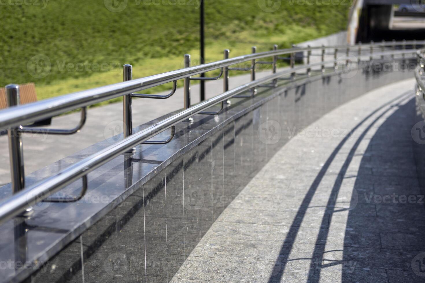 Long row of polished stainless steel ramp for going up or down photo
