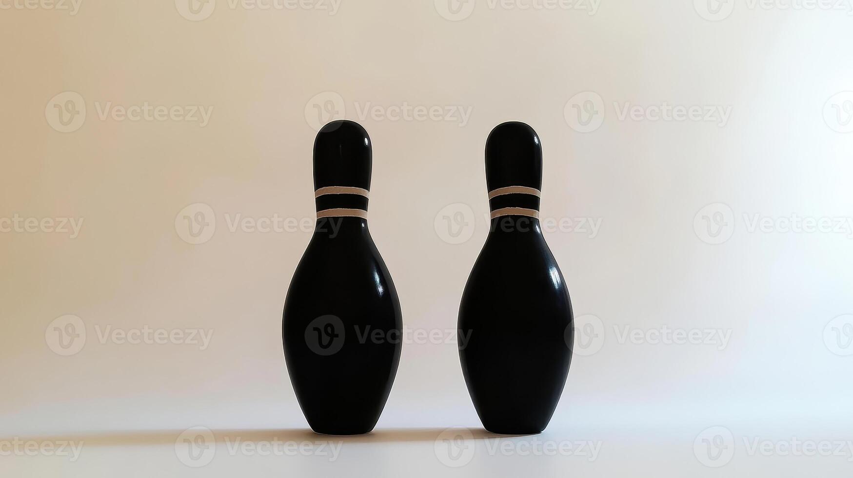 Minimalist black bowling pins standing side by side on a neutral background photo
