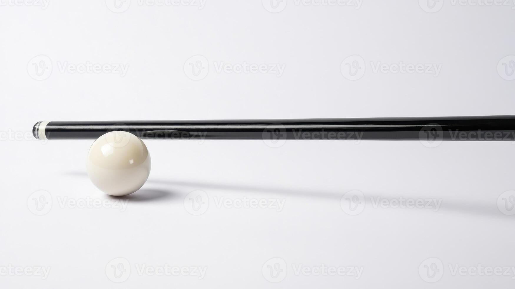 Black pool cue poised to strike white ball on a smooth surface in a game of billiards photo