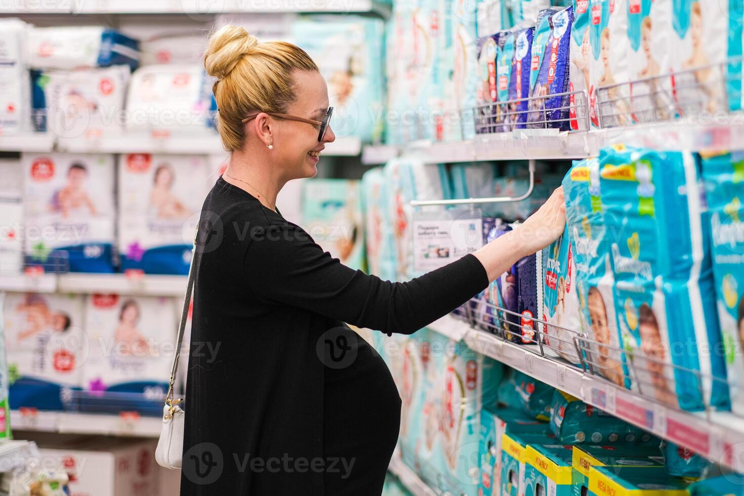 woman is looking for baby accessories or diaper in the shelf photo
