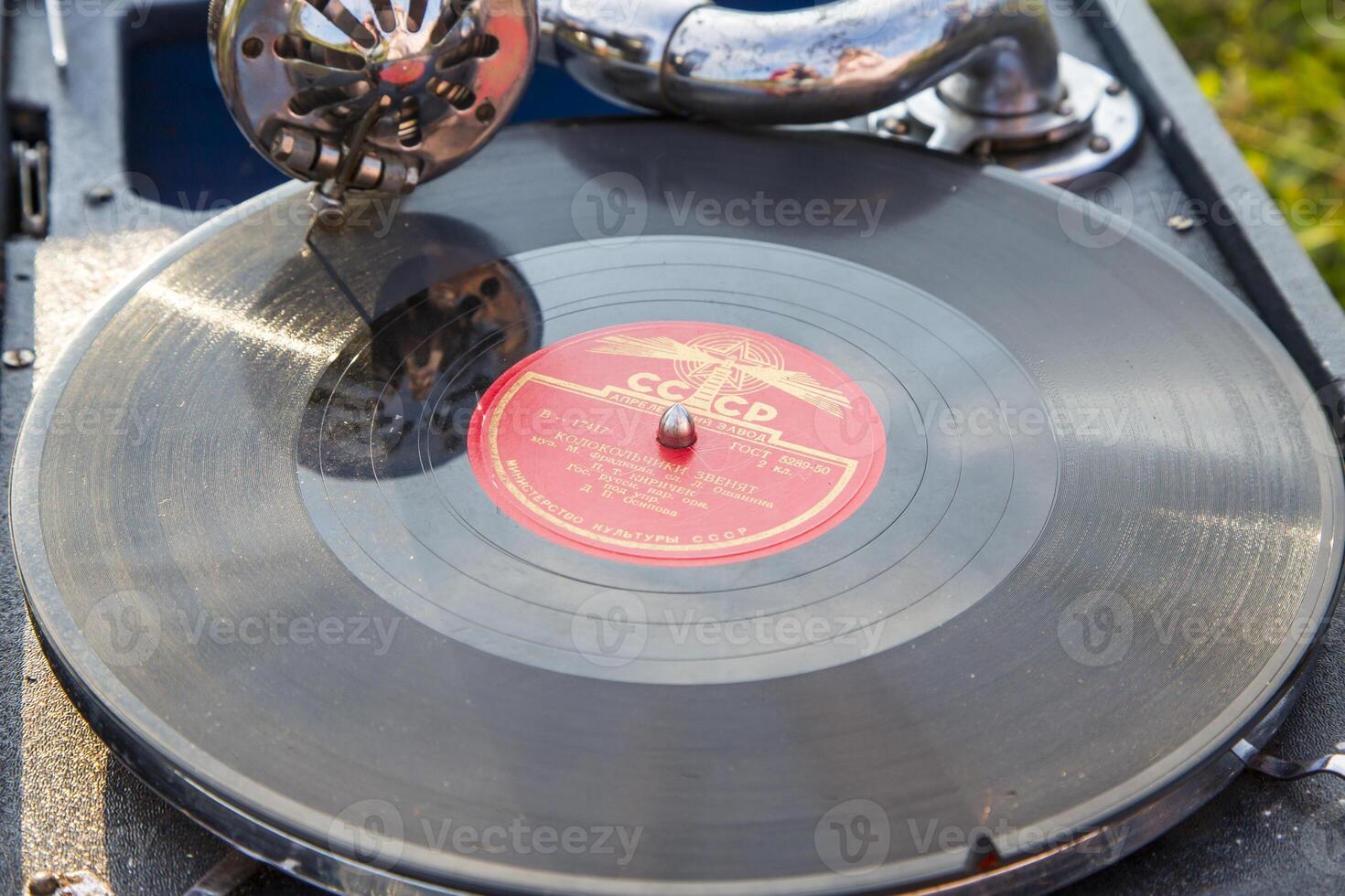 Moscow, Russia, 09.10.2017. A record player is spinning a record with the letters CC on it photo