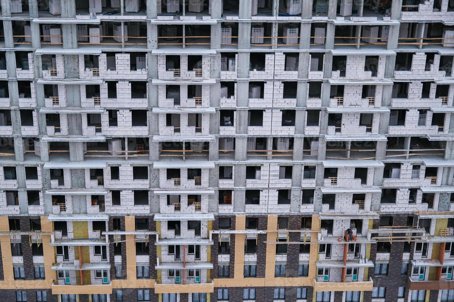 A large building with many windows and a lot of scaffolding photo