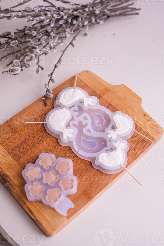 Moscow, Russia, 18.04.25. A wooden cutting board with two different shaped molds on it photo