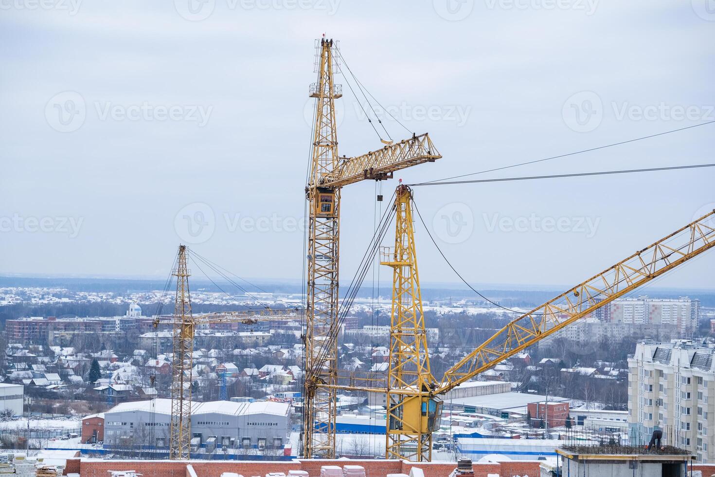 A construction site with a crane in the middle of the scene photo