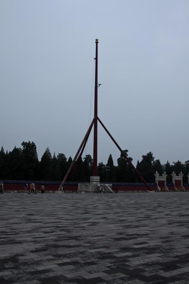 Beijing, China, 14.07.2010. A tall pole with a flag on top stands in a field photo