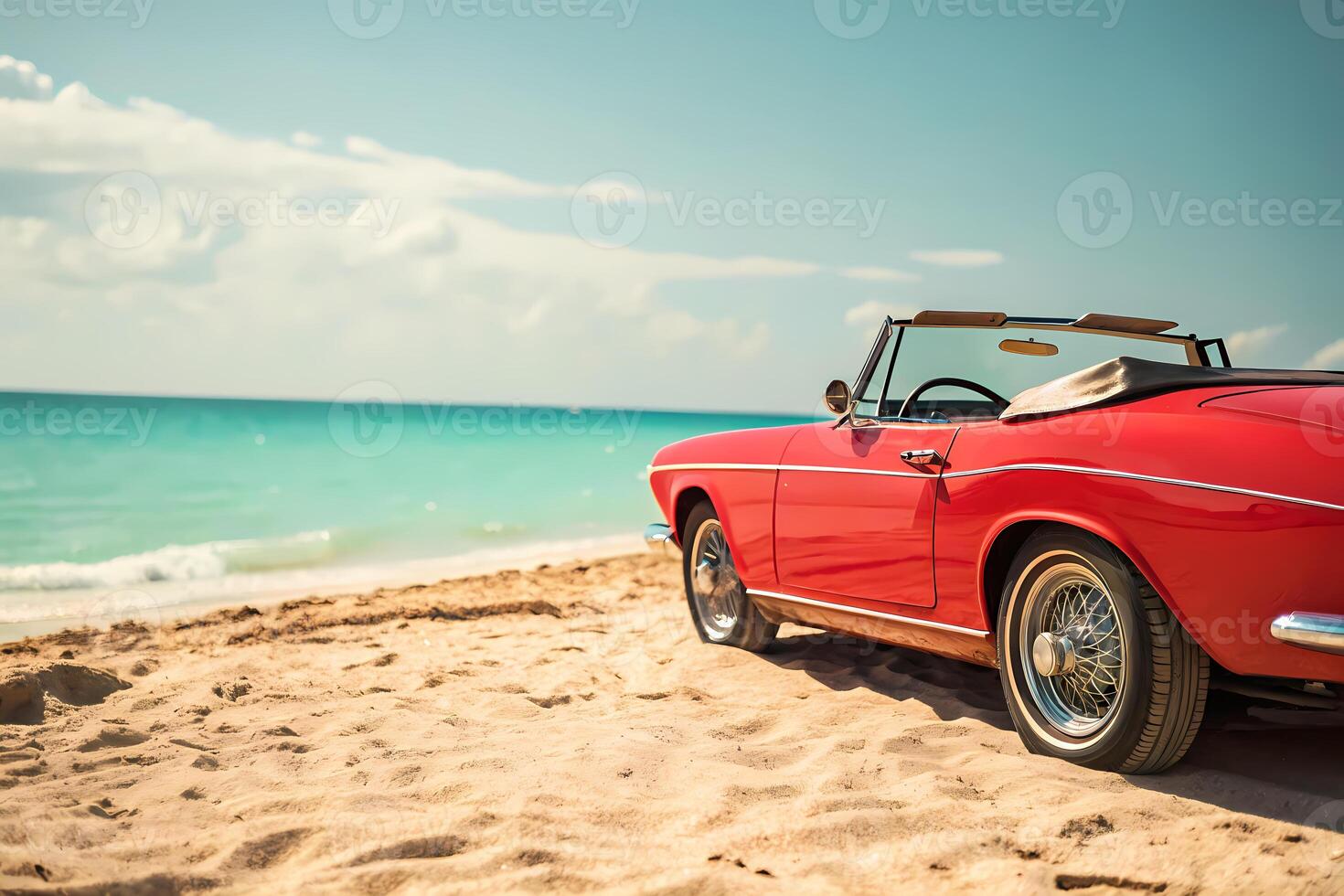 Red convertible car parked on a sandy beach enjoying summer vacation photo