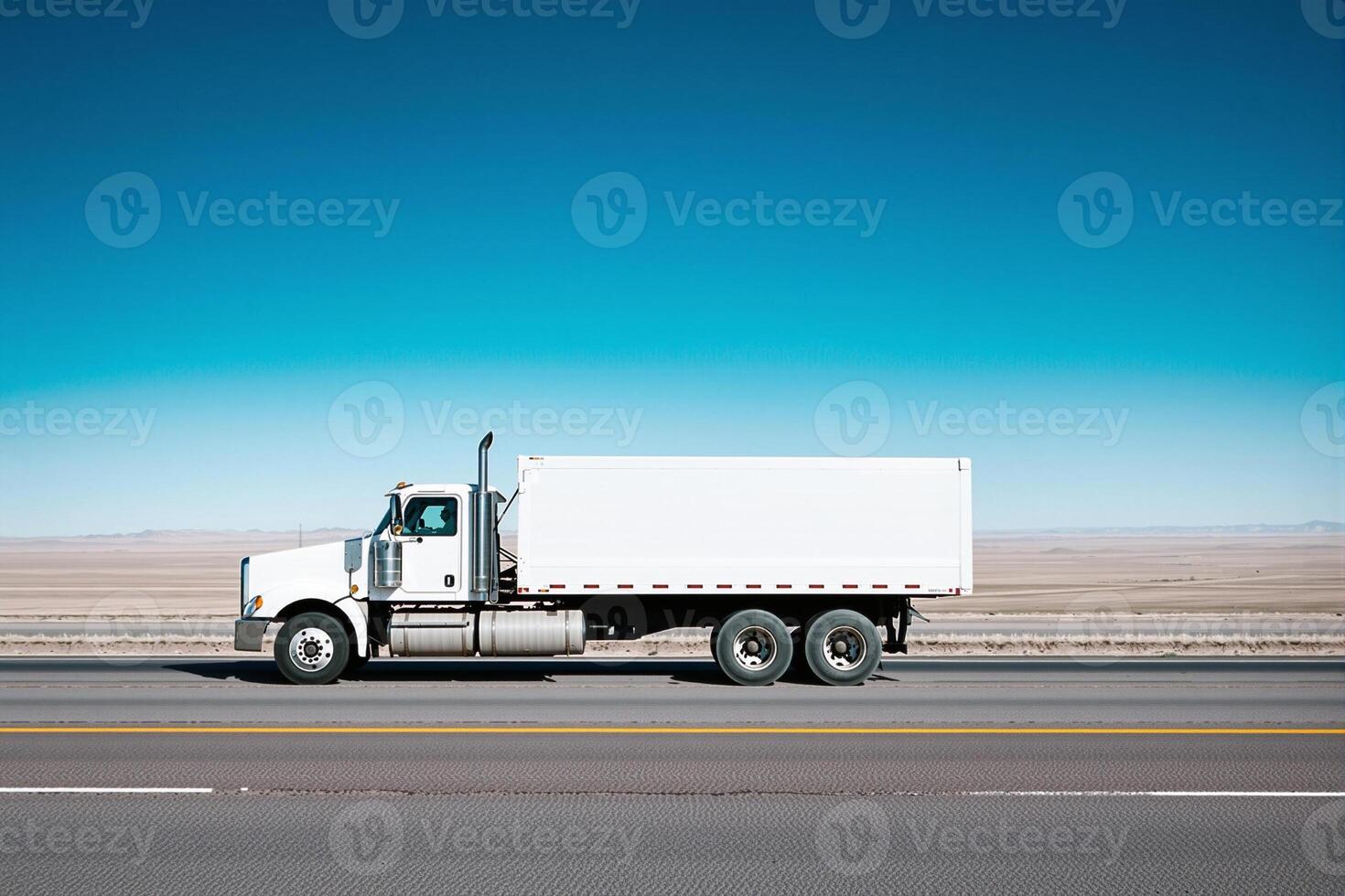 White truck driving on desert highway under blue sky photo