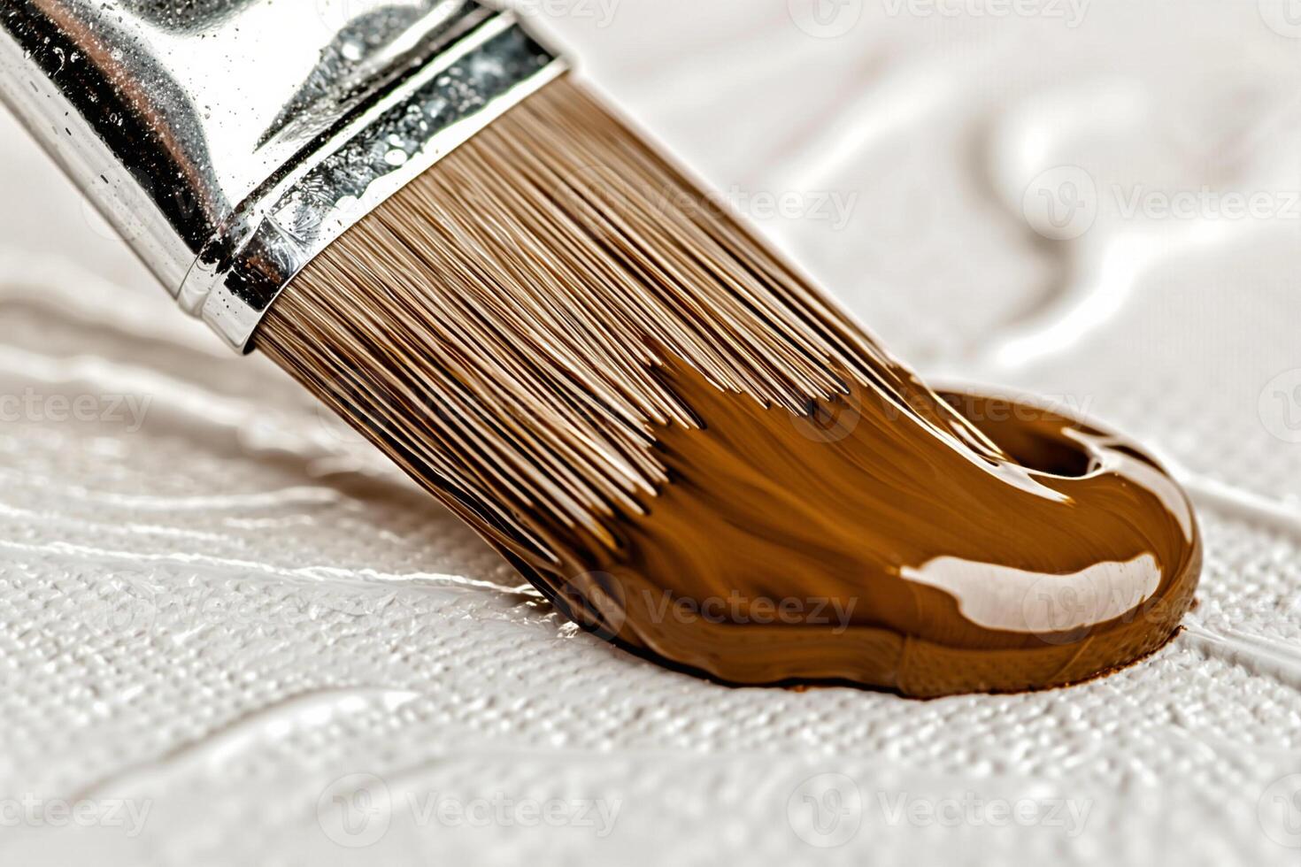 Paintbrush applying brown paint on white canvas, painting tools and artistic creation photo