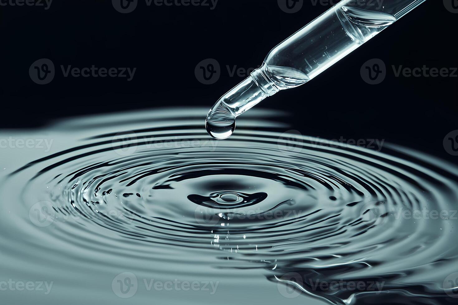 Pipette dropping serum into water creating concentric ripples photo