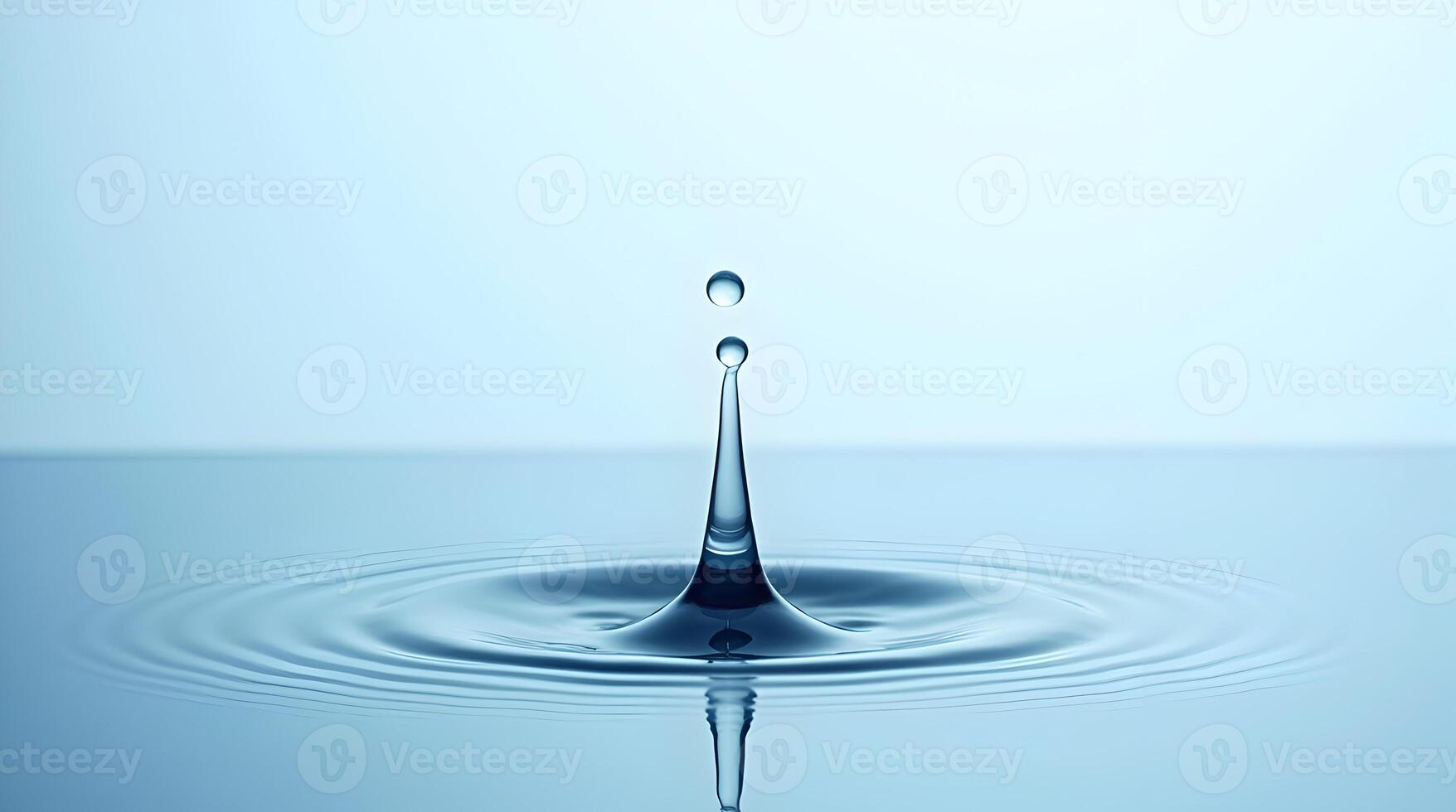 Water drop with ripple on blue surface photo