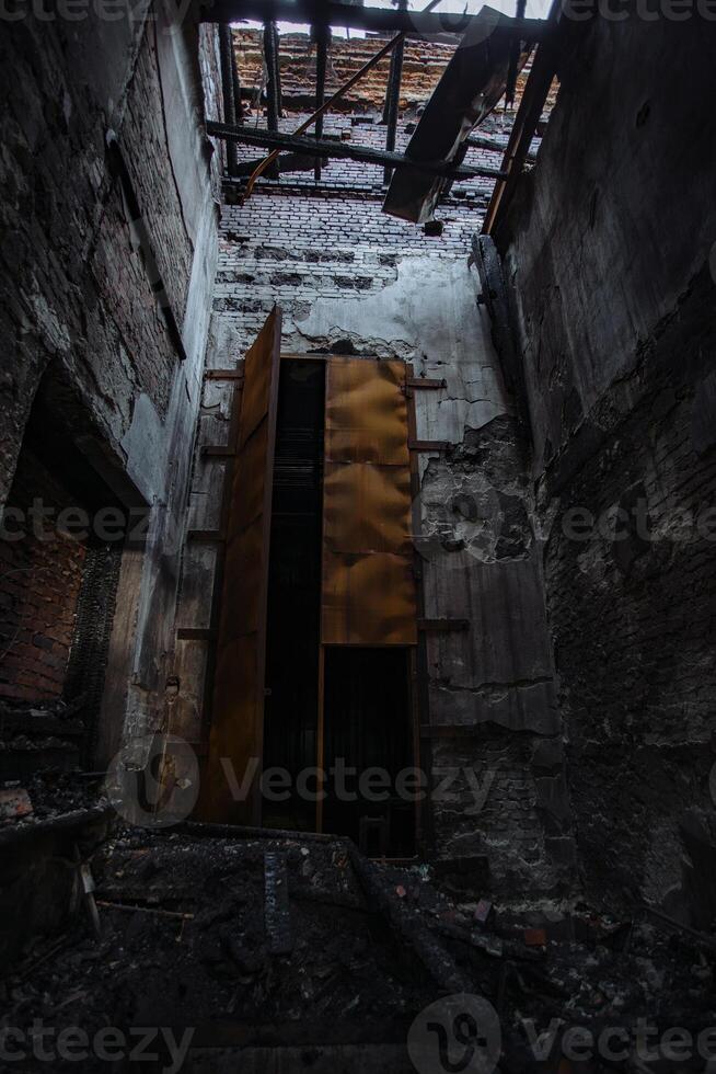 Fire aftermath, burnt building, charred walls in black soot photo