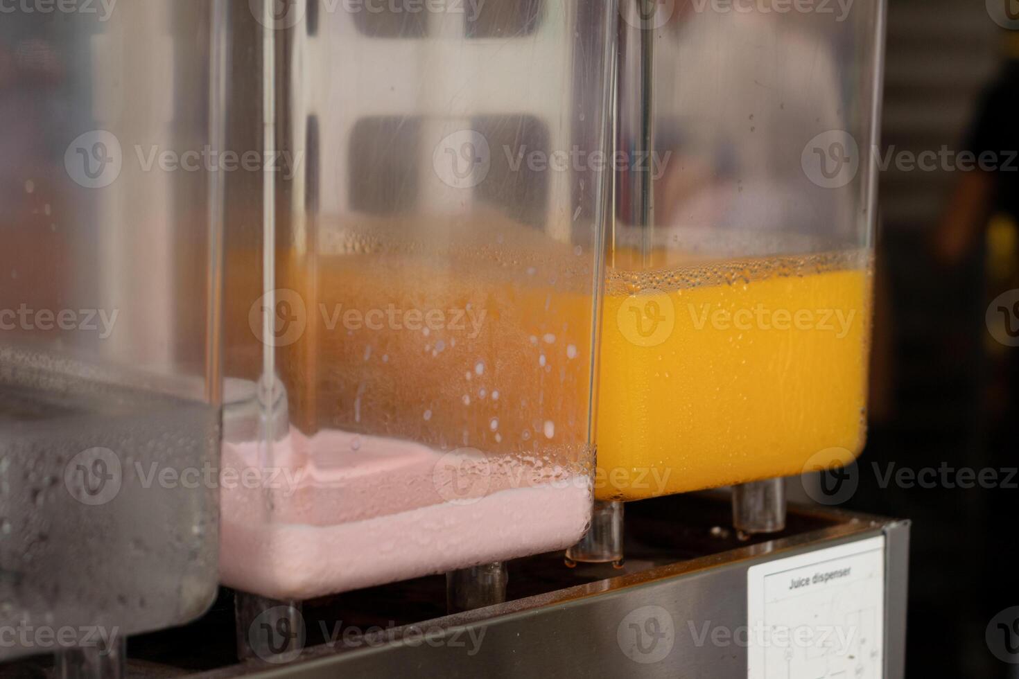 Fruit juice in a plastic dispenser at a market stall. After edits. photo