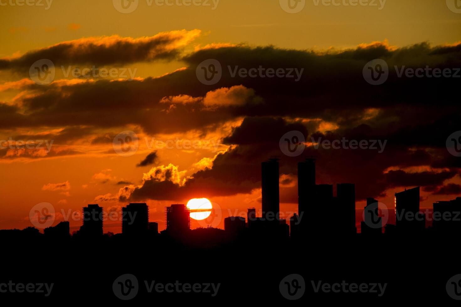 sunset on a cloudy day among the big buildings of the city photo