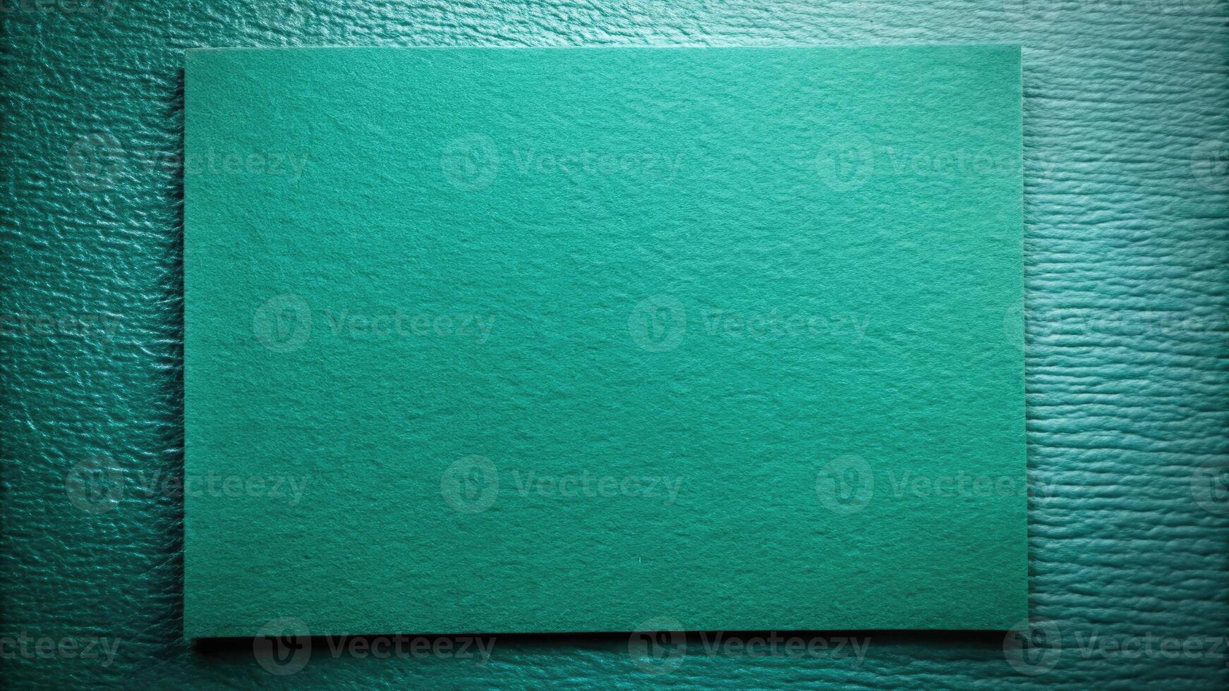 Textured teal rectangular panel on a dark background. photo