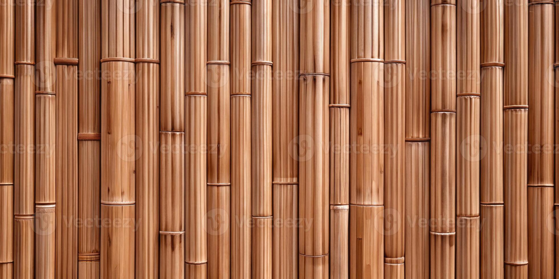 Vertical bamboo stalks create a natural and serene pattern. photo