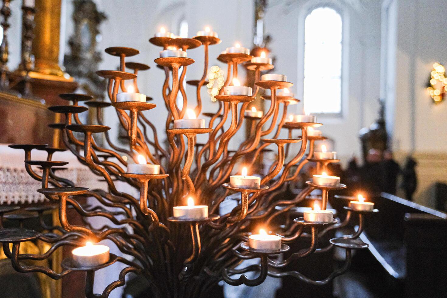 Grodno, Belarus, 03.01.2025 A large candle holder with many candles lit photo