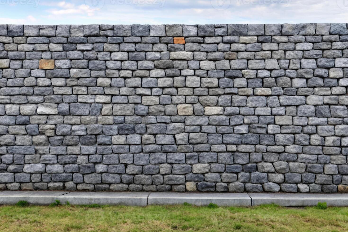 Sturdy stone wall with neatly arranged gray bricks. photo