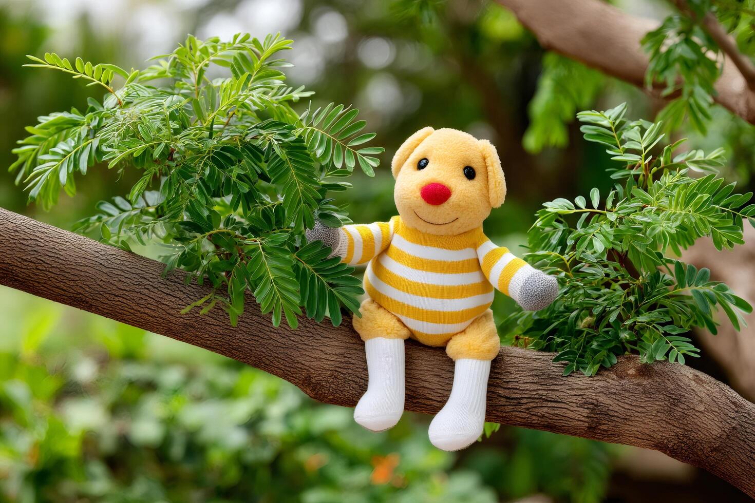 Yellow plush dog sitting on a tree branch enjoying nature photo