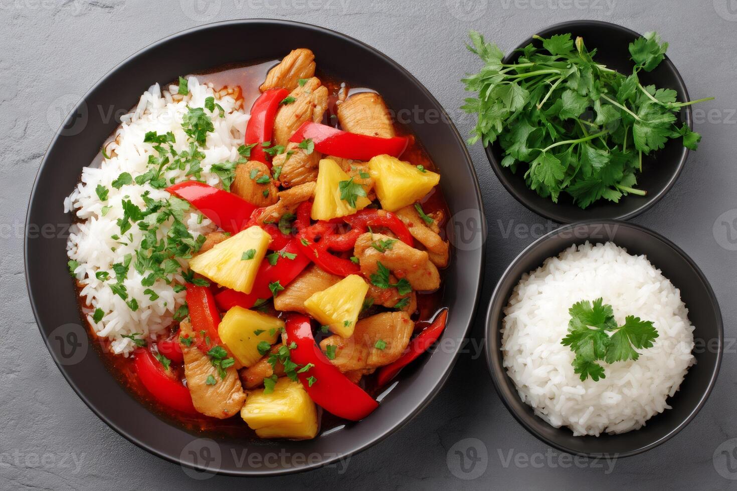 Chicken and pineapple curry with rice and red bell peppers garnished with parsley photo
