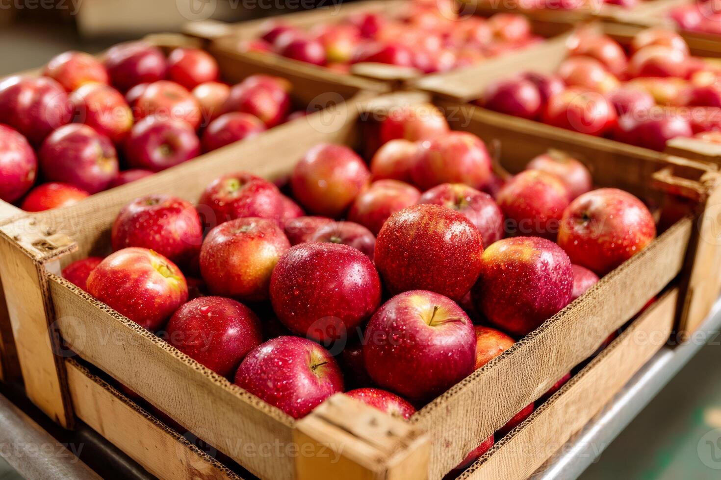 Fresh red apples stacked in wooden crates inside a warehouse photo