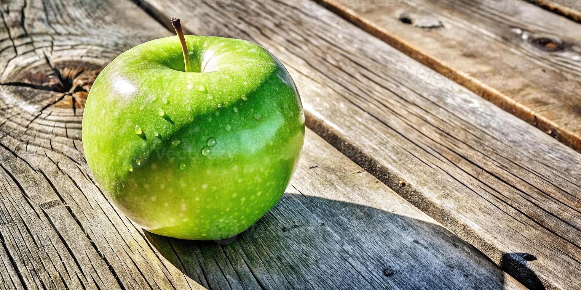 Fresh green apple on a weathered wooden table. photo