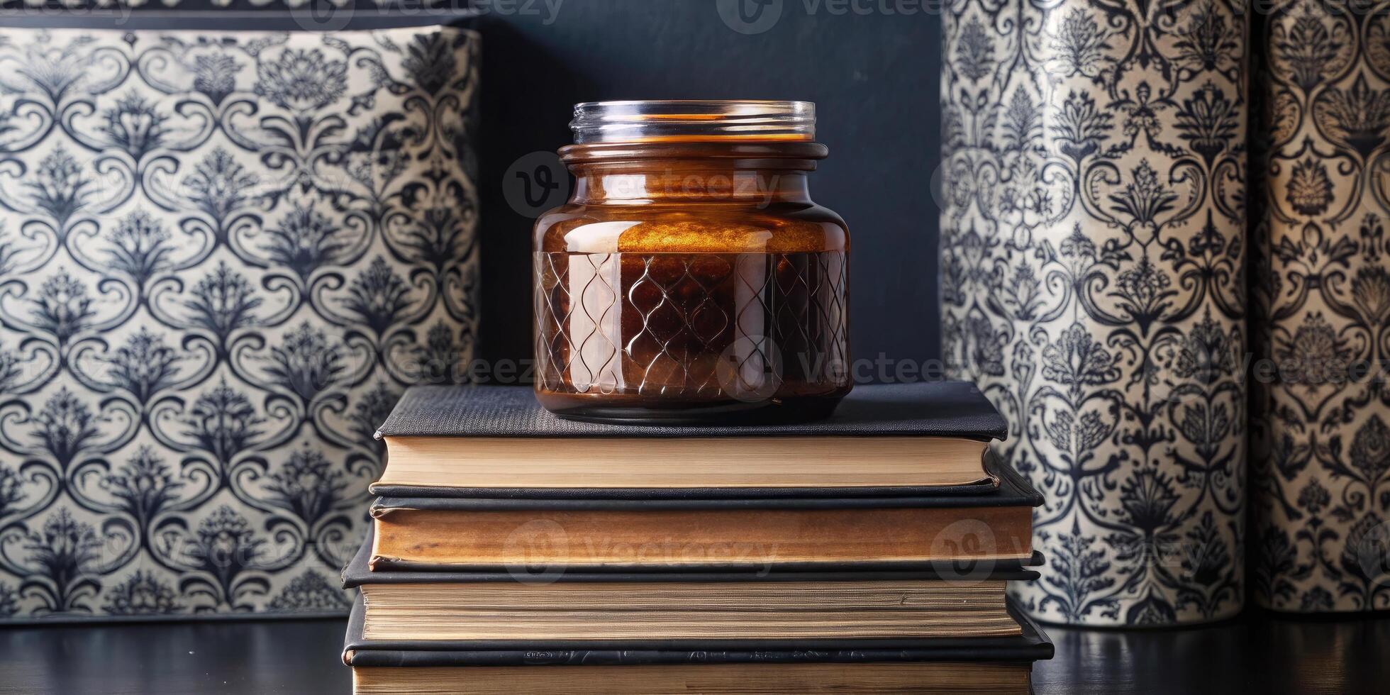Vintage books stacked beside a decorative jar. photo