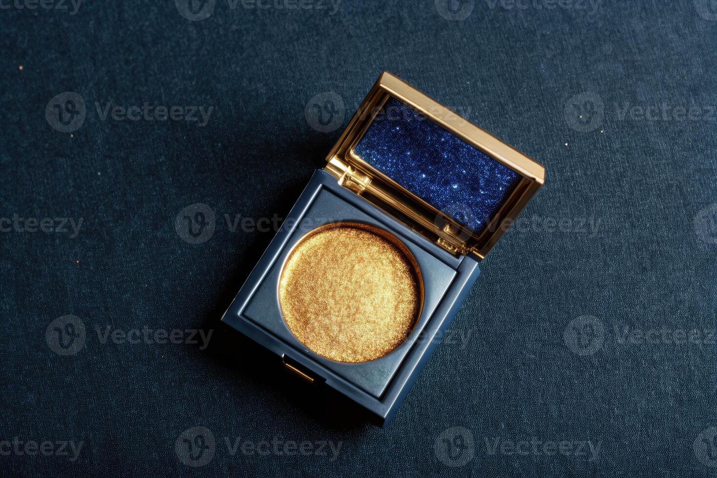 Luxurious golden eyeshadow in an open compact. photo