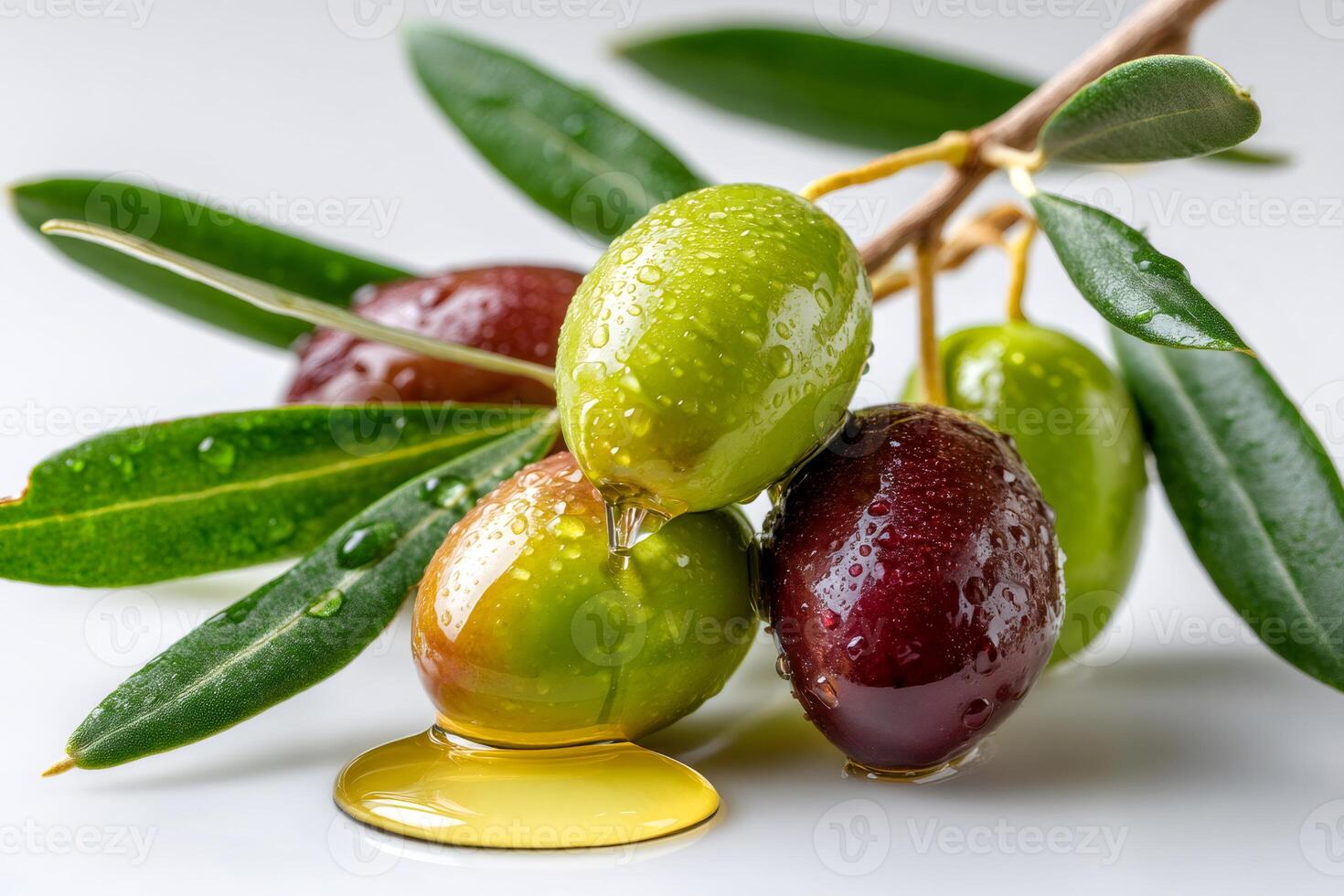Fresh olives dripping oil with leaves covered in water drops photo