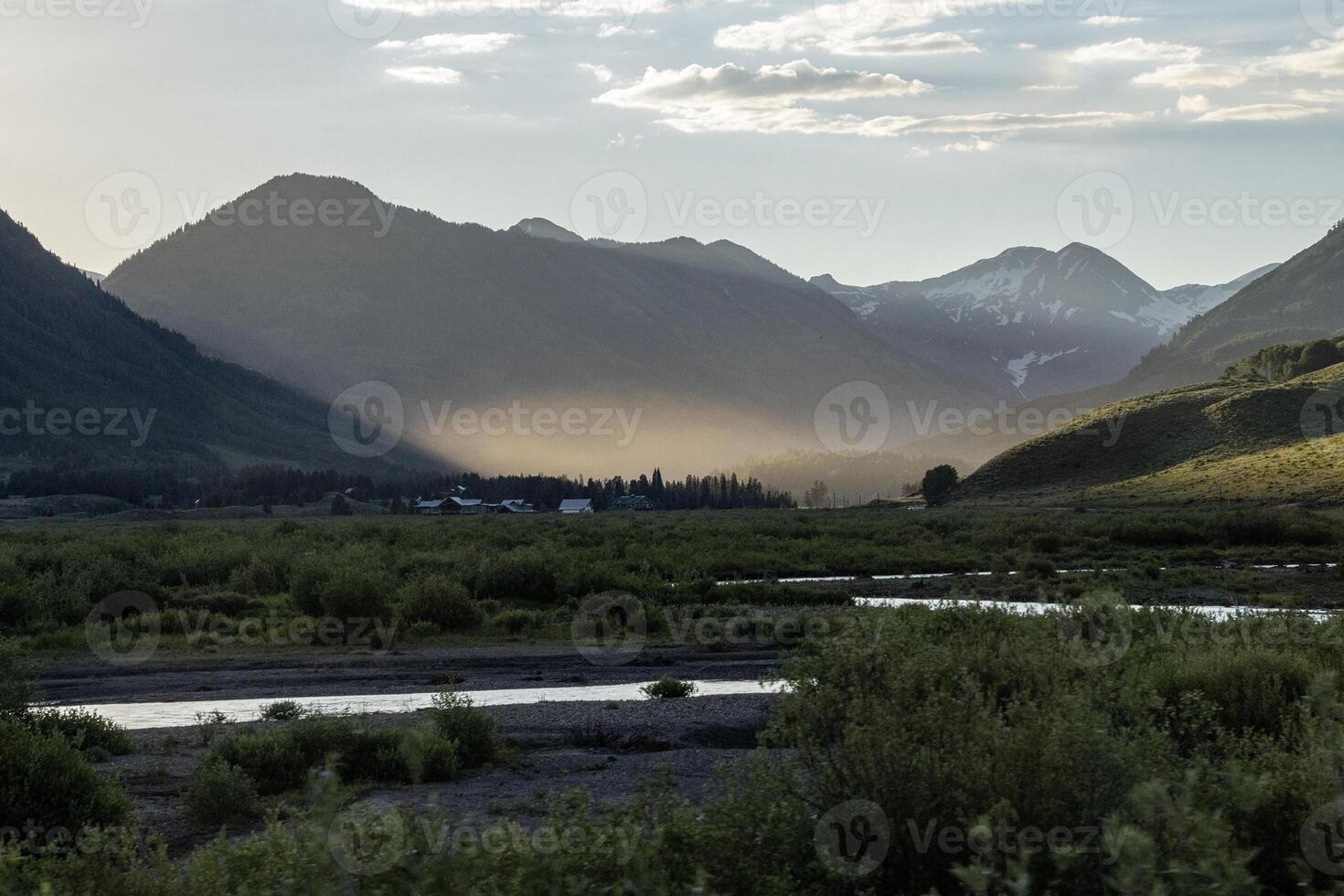 Natural landscape showcasing mountains and valleys during golden hour with gentle light illuminating the scene photo