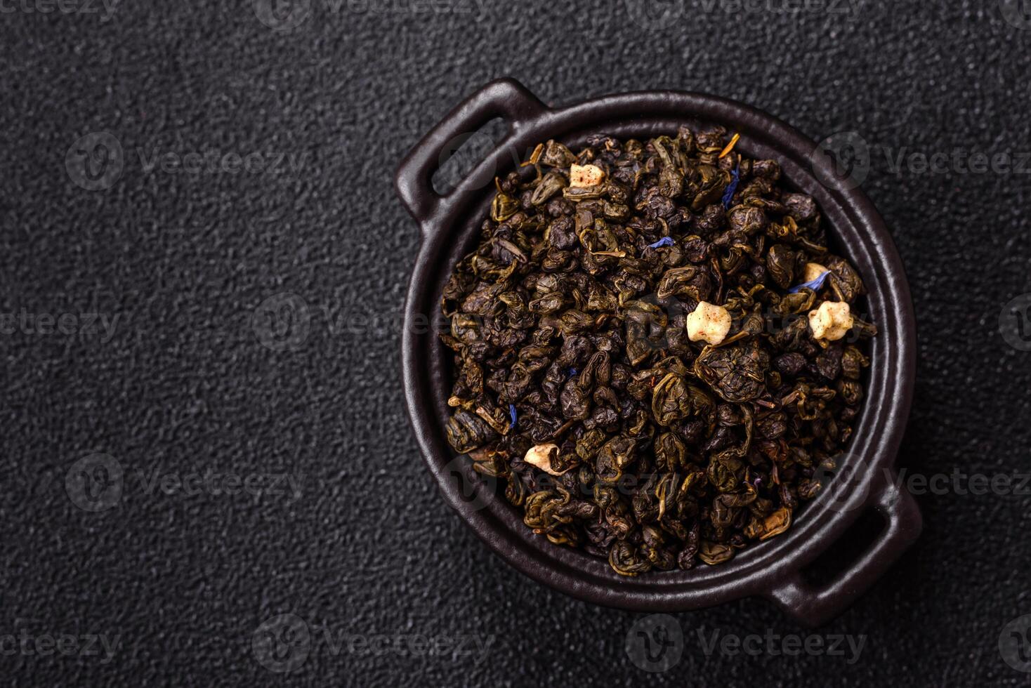 Green tea with soursop piece, knapweed petals in bowl photo