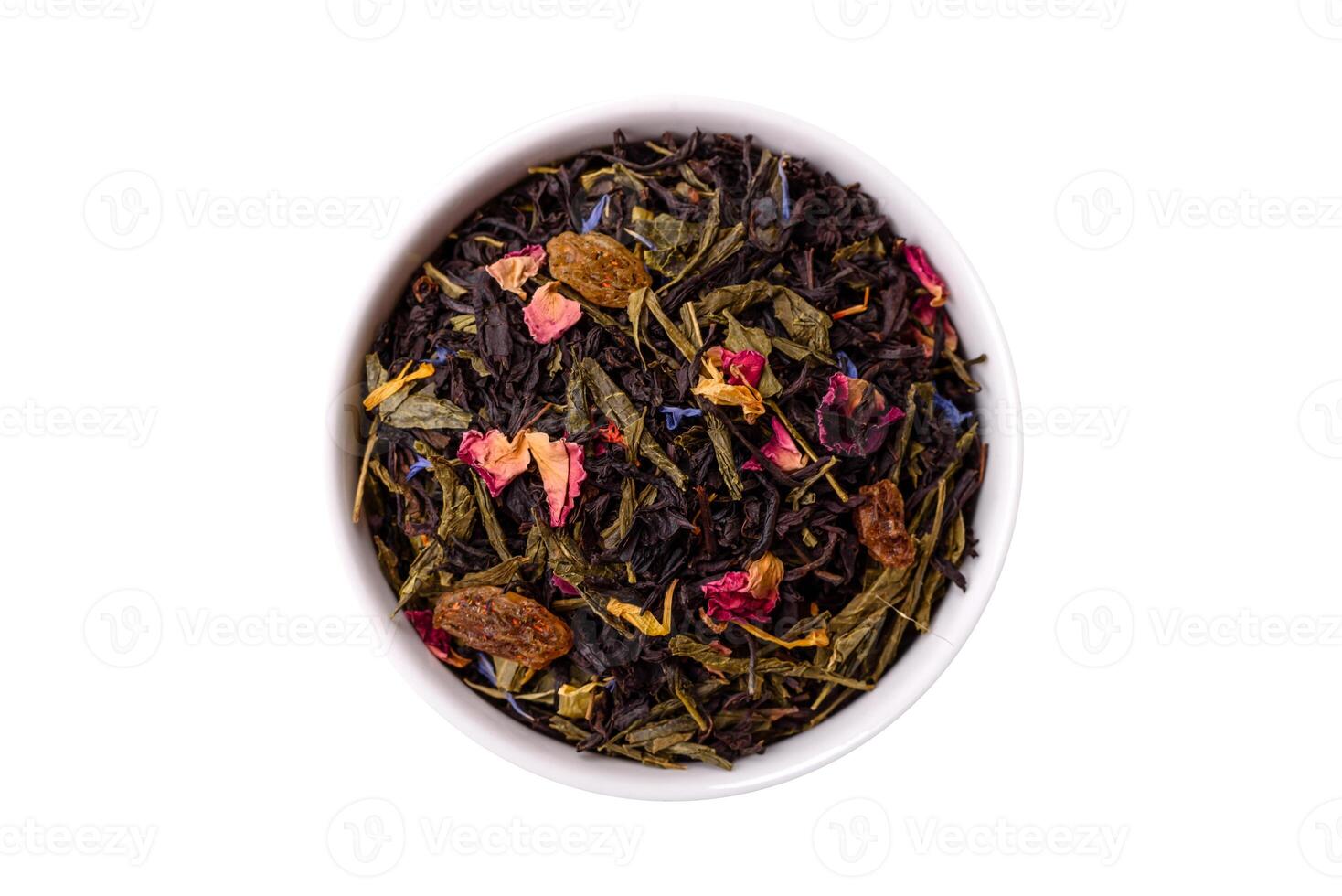 Dry tea mix blend black, green and flower petals in bowl. Isolated photo