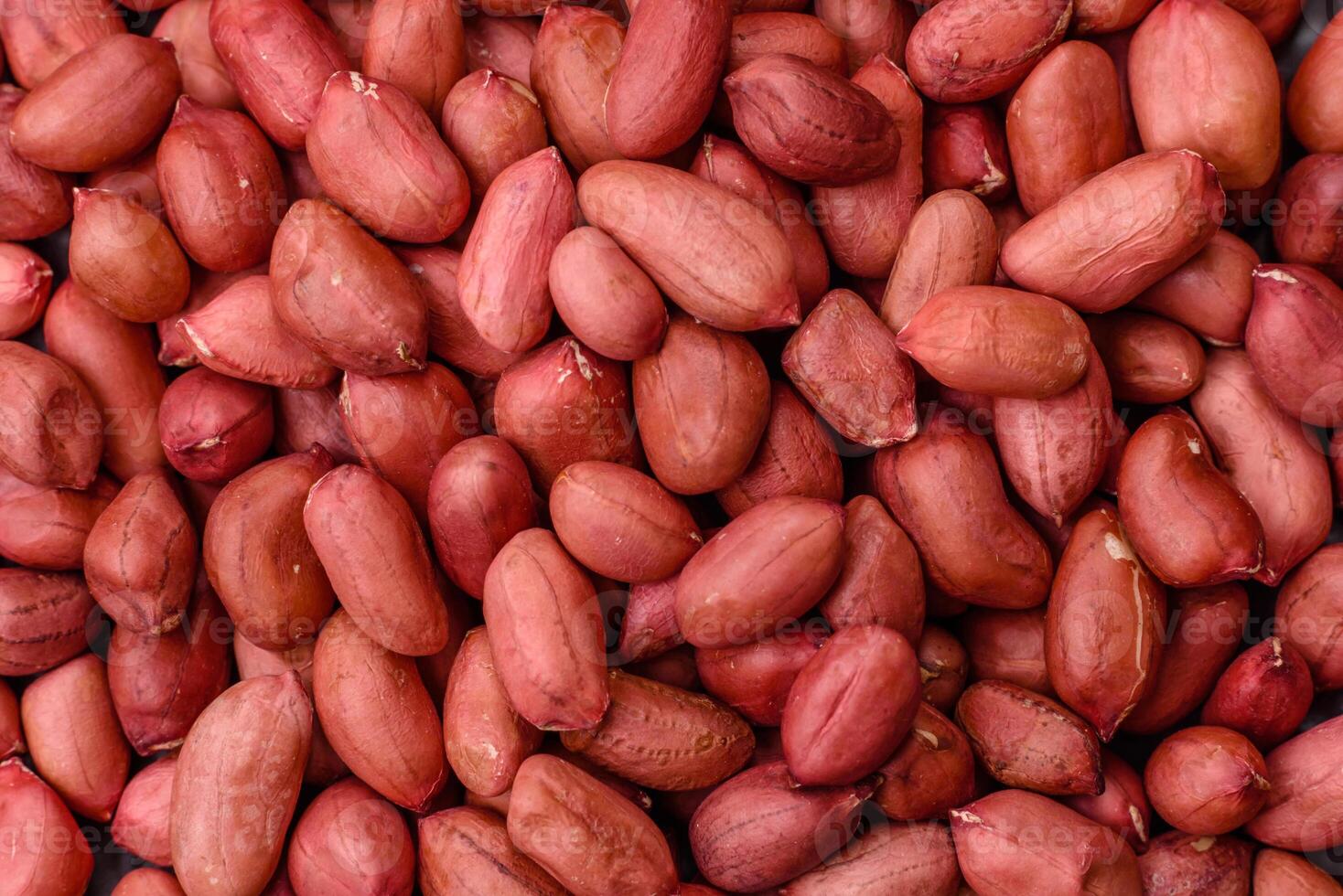 Peanuts in a bowl on a dark concrete background photo