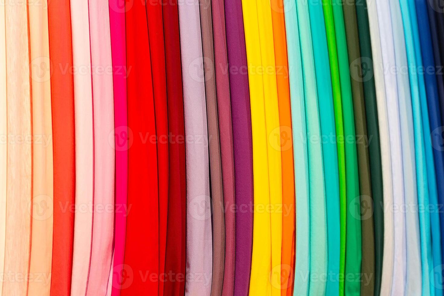 Multi-colored textiles on the shop window photo