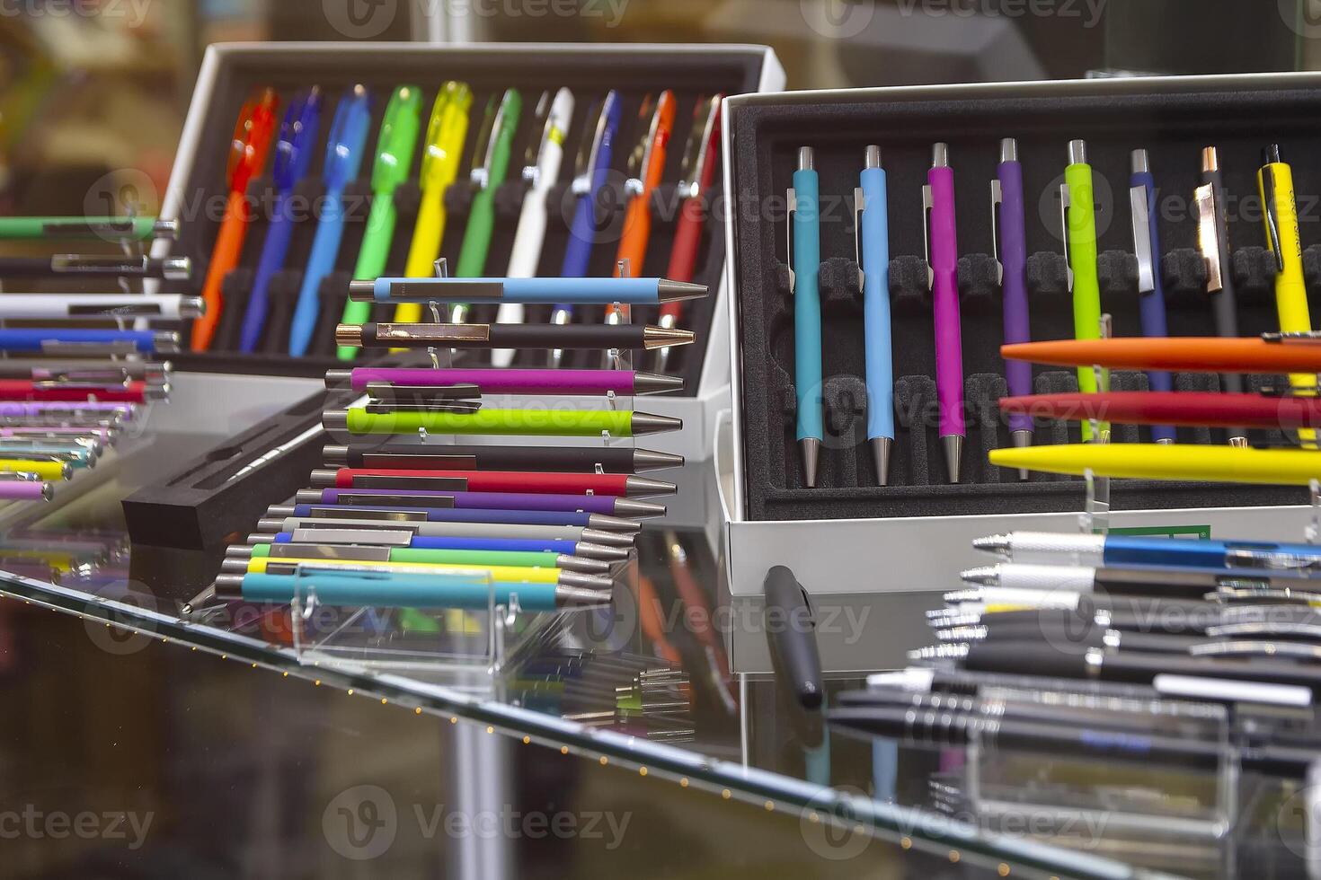 Modern colored plastic ballpoint pens on store display. Sale photo