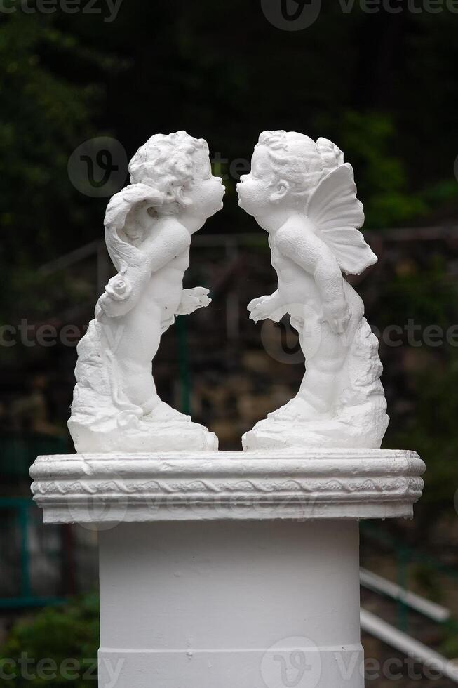 Angels leaning towards a kiss photo