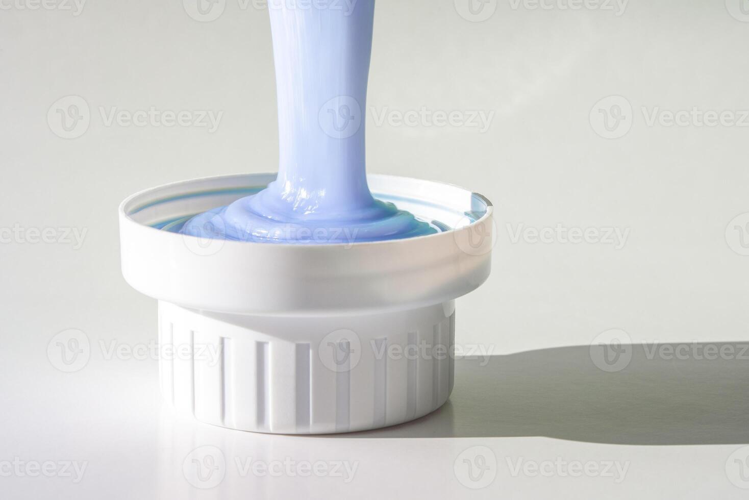 Pouring Laundry Fabric Softener in a Cap photo