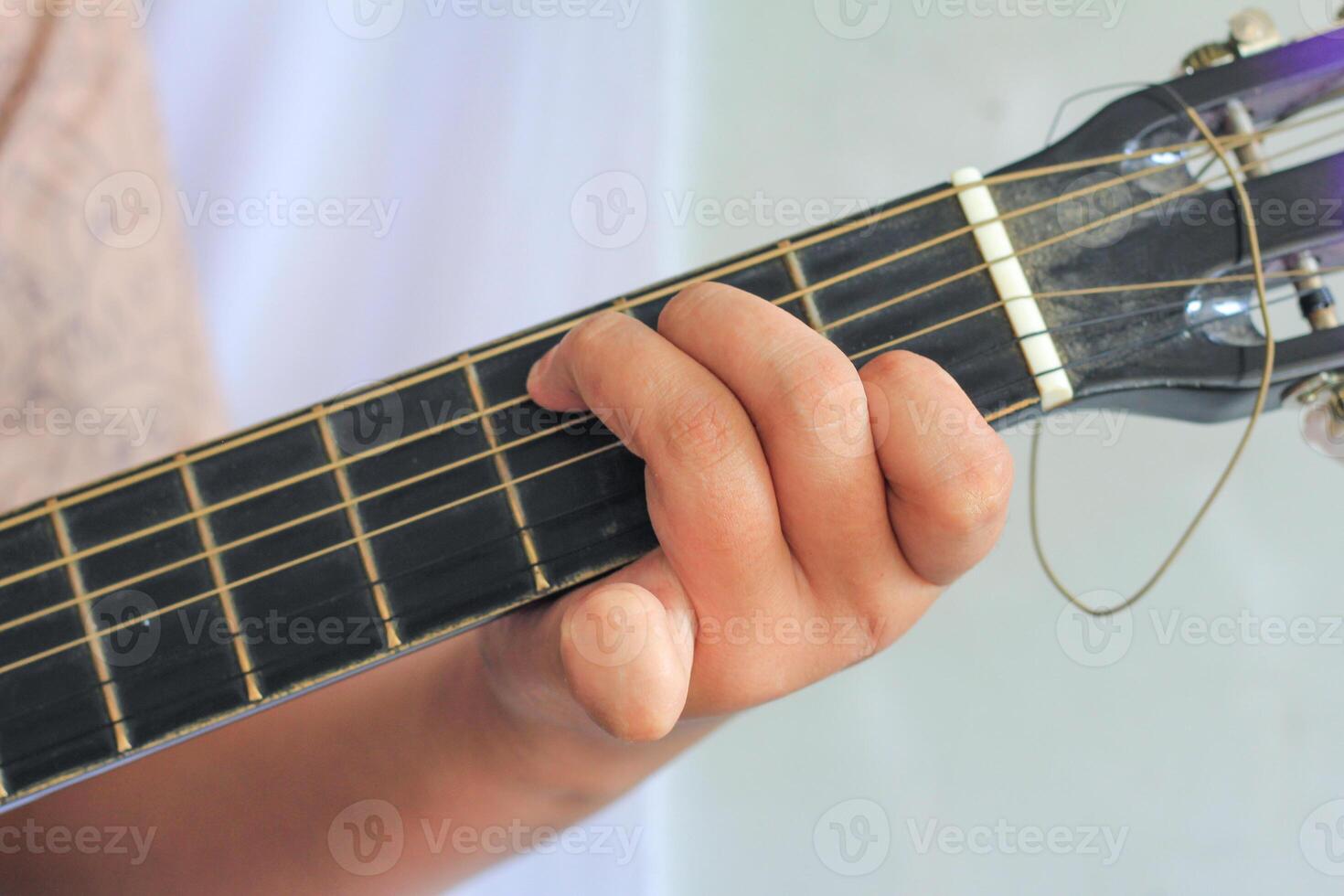 Guitarist Pressing Strings with Accurate Finger Placement Technique photo