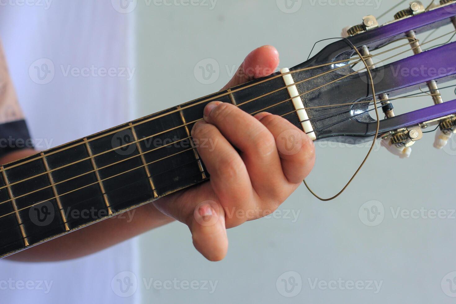 Practicing Chords on Acoustic Guitar Fretboard with Precision photo