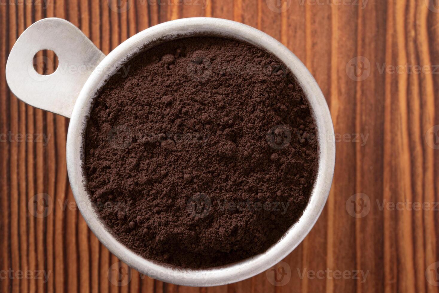 Dark Chocolate Powder in a Vintage Measuring Cup photo