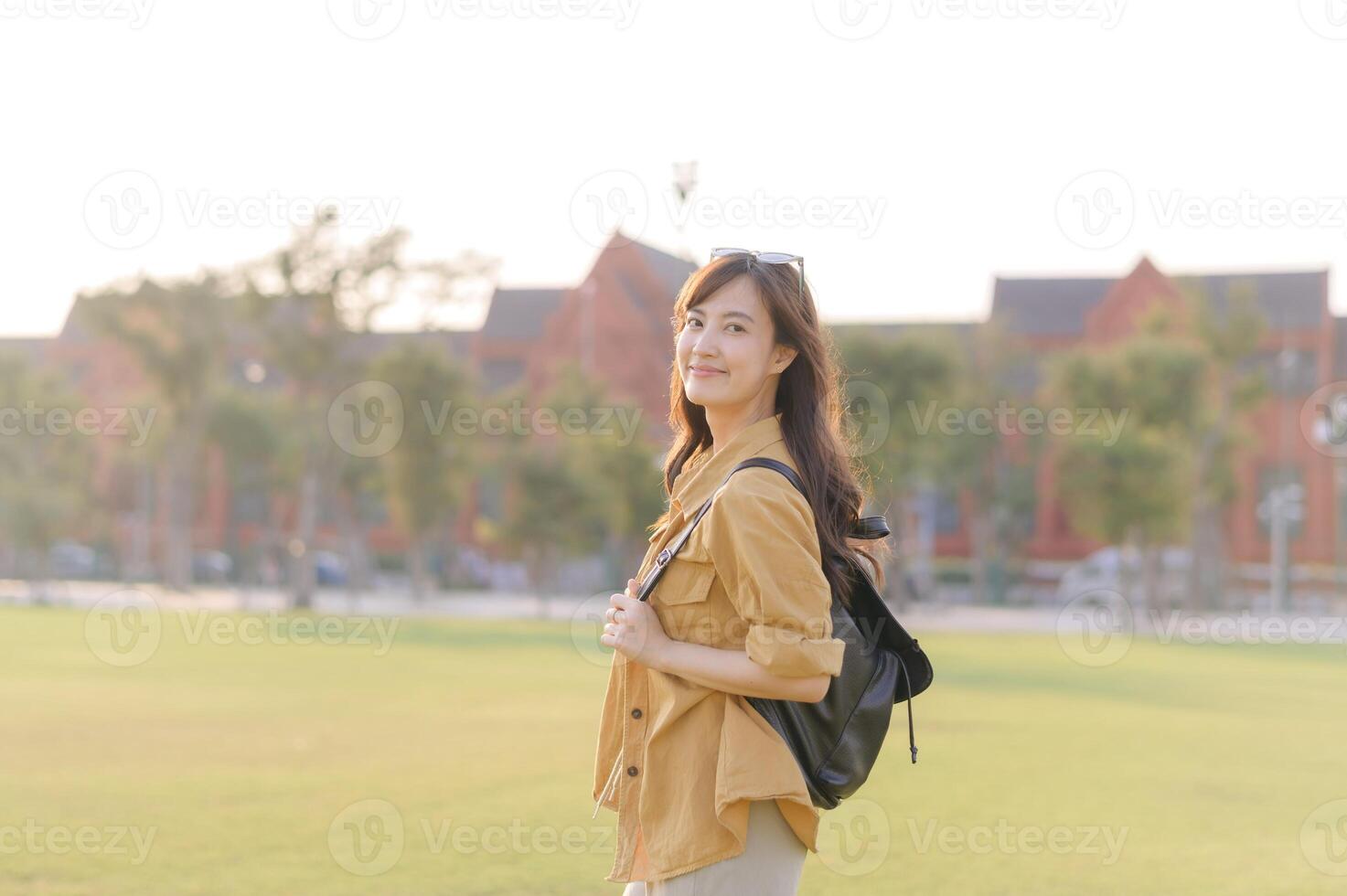 Asian woman with backpack walking in the park photo