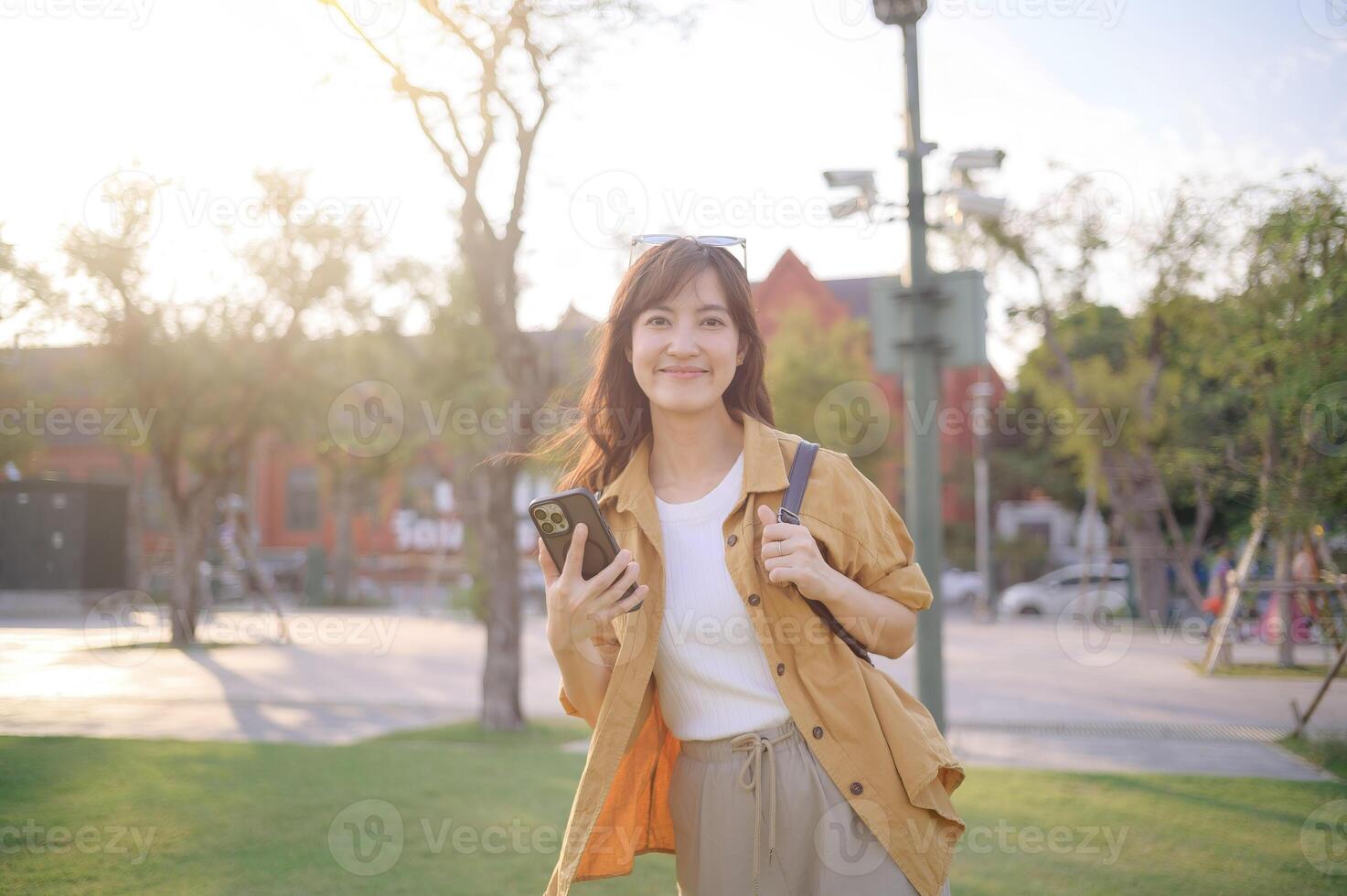 Asian woman using smartphone in park photo