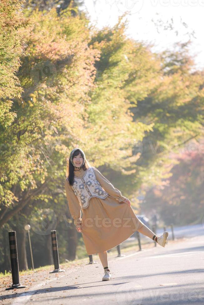 A woman is standing on a street corner photo