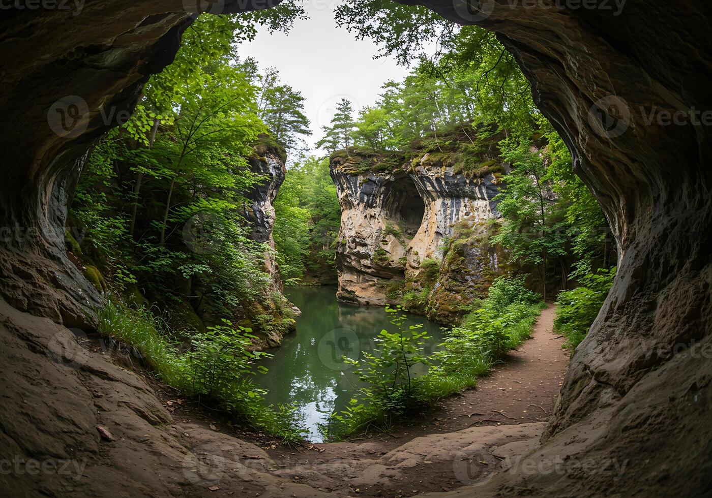 A view of a river through a cave in the woods photo