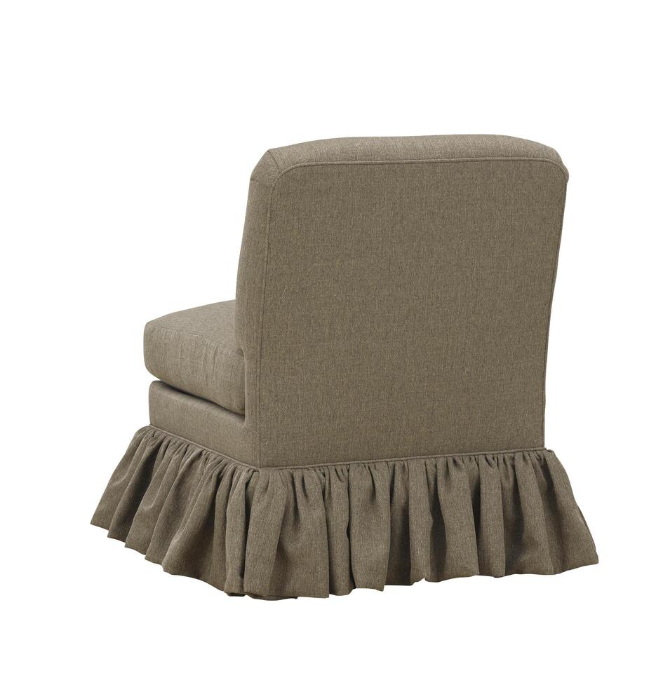 Upholstered accent chair with ruffled skirt in neutral color isolated photo